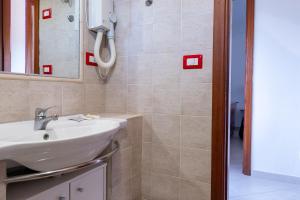 a bathroom with a sink and a mirror at Jerà D72 Vista Mare in Vulcano +13 photos