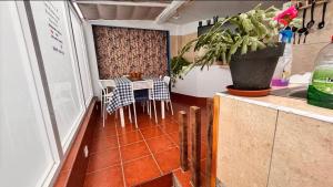 a kitchen with a table and chairs in a room at O Lar Tuna in Pereiro +37 photos