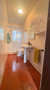 a bathroom with a sink and a toilet at O Lar Tuna in Pereiro