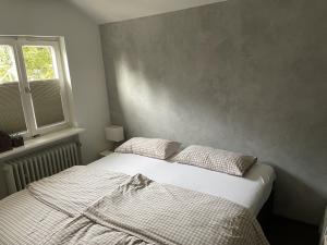 a bedroom with a bed with two pillows and a window at Ferienhaus Lena in Seebach