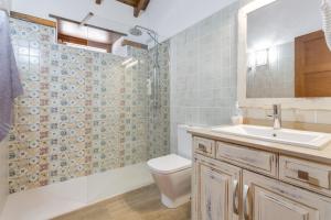 a bathroom with a toilet and a sink and a shower at Volcán 16 in Tanque +9 photos