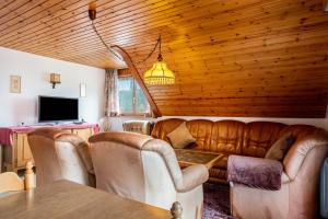 a living room with a couch and a table at Haus Irmgard in Lenzkirch