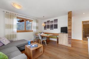 a living room with a couch and a table at Ederhof in Schenna