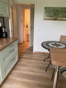 a kitchen with a table and a counter top at ehemaliges Gutsverwalterhaus in Mildenitz