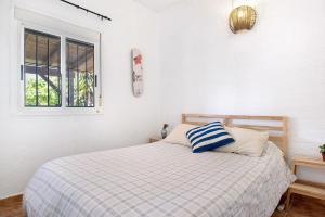 a bedroom with a bed and a window at Casa Luna in Los Caños de Meca +22 photos
