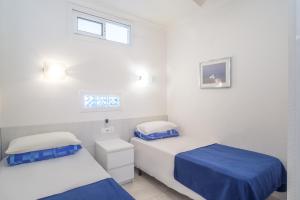 a bedroom with two beds and a window at Stunning Marina view apartment in Fuengirola