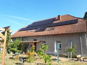 a house with solar panels on the roof at ehemaliges Gutsverwalterhaus in Mildenitz +4 photos