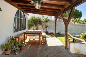 a wooden deck with a table and chairs on it at Casa Luna in Los Caños de Meca