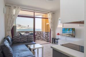 a living room with a couch and a table at Stunning Marina view apartment in Fuengirola