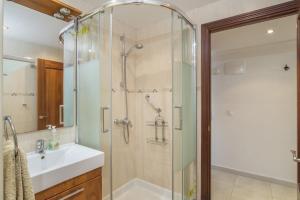 a bathroom with a shower and a sink at Stunning Marina view apartment in Fuengirola +14 photos