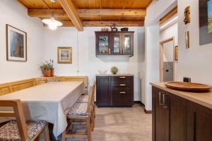 a kitchen with a table and chairs in a room at Ginepro Casa Vacanze in Madesimo