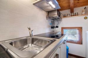 a stainless steel sink in a small kitchen at Ginepro Casa Vacanze in Madesimo +18 photos
