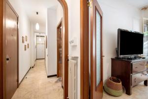 a hallway with a television on a dresser and a mirror at Casa Lulu' in Lavagna
