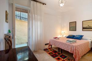 a bedroom with a bed and a large window at Casa Lulu' in Lavagna