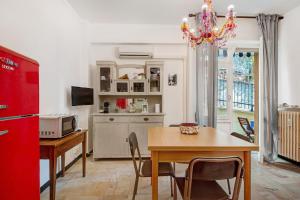 a kitchen with a dining table and a red refrigerator at Casa Lulu' in Lavagna