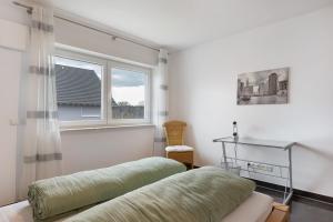 a bedroom with a bed and a window at Fewo Am Otterbach in Jockgrim