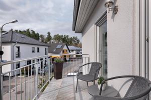 a balcony with two chairs and a table at Fewo Am Otterbach in Jockgrim