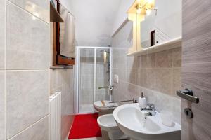 a white bathroom with a toilet and a sink at Casa Vacanza Malva in Baveno +17 photos
