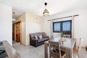 a living room with a table and a couch at Casa Maruca 1 in Valverde