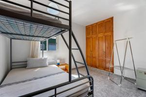 a bedroom with a bunk bed and a wooden cabinet at Casa Maruca 1 in Valverde
