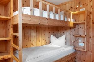 a wooden room with bunk beds in it at Villa Solinda App Vivaldi in Selva