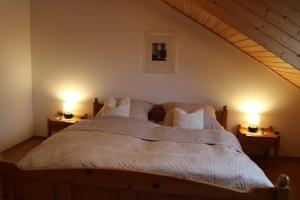 a bedroom with a bed with two lights on two tables at Apartment Gartenblick in Korbach