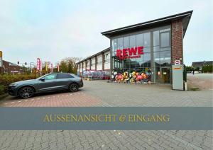 a car parked in a parking lot in front of a building at Flexi Flats in Lingen