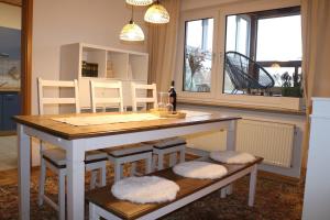 a kitchen with a table and chairs and a dining room at Apartment Gartenblick in Korbach