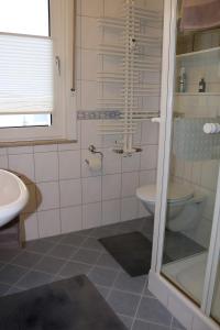 a bathroom with a toilet and a sink at Apartment Gartenblick in Korbach +16 photos