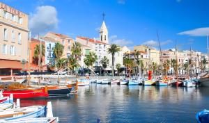 a group of boats docked in a harbor with buildings at Studio Sanary in Sanary-sur-Mer
