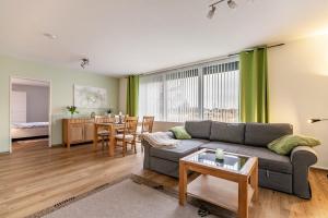 a living room with a couch and a table at Ferienhaus Dunklau in Wesselburen