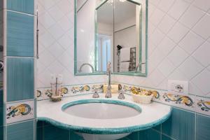 a bathroom with a sink and a mirror at Suite Aurora in dependance in Conca dei Marini +16 photos