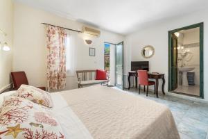 a bedroom with a bed and a living room with a desk at Sa Funtana in Gonnesa