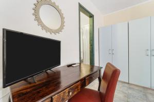 a flat screen tv sitting on top of a wooden table at Sa Funtana in Gonnesa +65 photos