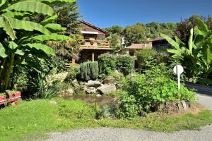 a garden in front of a house at Au Fil De L'eau in Chein-Dessus +13 photos
