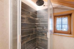 a shower with a glass door in a bathroom at Appartamento Gemma in Livigno +22 photos