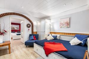 a bedroom with a blue bed and a blue chair at Hof Islandpferde von der Holstenau in Eggstedt