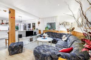 a living room with a couch and a table at Hof Islandpferde von der Holstenau in Eggstedt