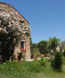 a house with flowers on the side of it at Sa Funtana in Gonnesa