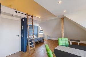 a room with a loft bed and a table and chairs at Ferienwohnung Skyline Suite in Bayreuth