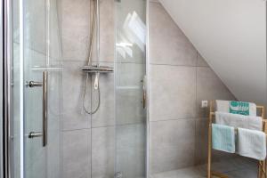 a shower with a glass door in a bathroom at Ferienwohnung Skyline Suite in Bayreuth