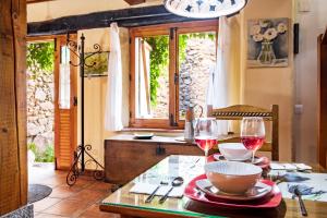 a table with two glasses of red wine on it at La Tarabilla in Casas del Abad