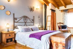 a bedroom with a large bed and a wooden table at La Tarabilla in Casas del Abad
