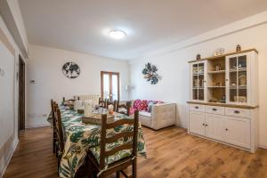 a dining room with a table and a couch at Casa Al Colle Buonconvento in Buonconvento +15 photos