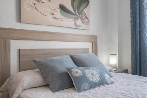 a bedroom with a bed with two pillows on it at Apartamento en Vejer in Vejer de la Frontera