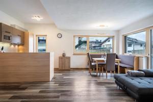 a kitchen and living room with a table and chairs at Steinwender in Kaltenbach