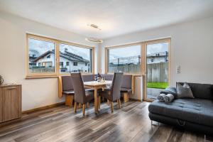 a living room with a table and chairs and a couch at Steinwender in Kaltenbach