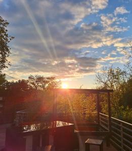 a sunset over a body of water with the sun shining at Le Refuge - Faucigny in Faucigny +8 photos