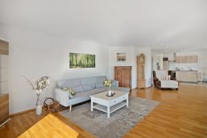 a living room with a couch and a table at Fewo Landschaftstraum am Bodensee in Lindau