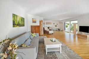 a living room with a couch and a table at Fewo Landschaftstraum am Bodensee in Lindau